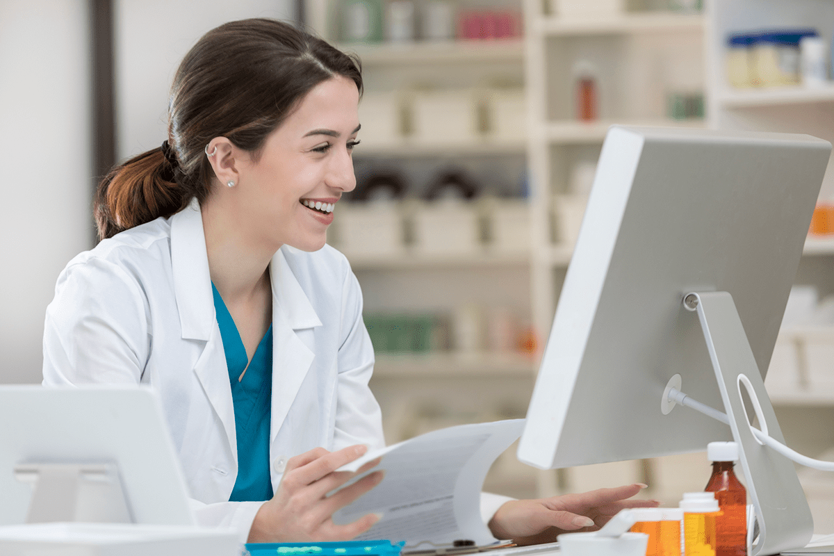Image of a pharmacist reading on the computer