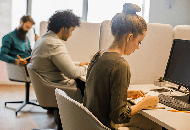 Three people taking an exam