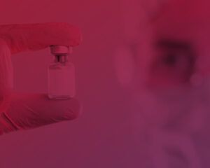 Image of a pharmacist holding a small bottle